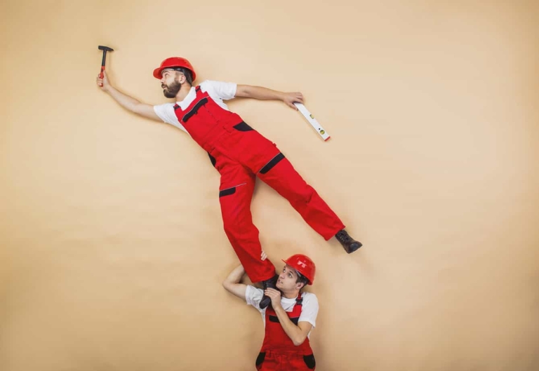 Construction workers have an accident. Funny studio poses. Workers in studio