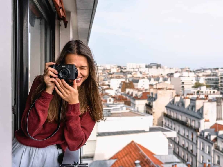 woman-wearing-maroon-sweater-standing-on-veranda-using-2272940